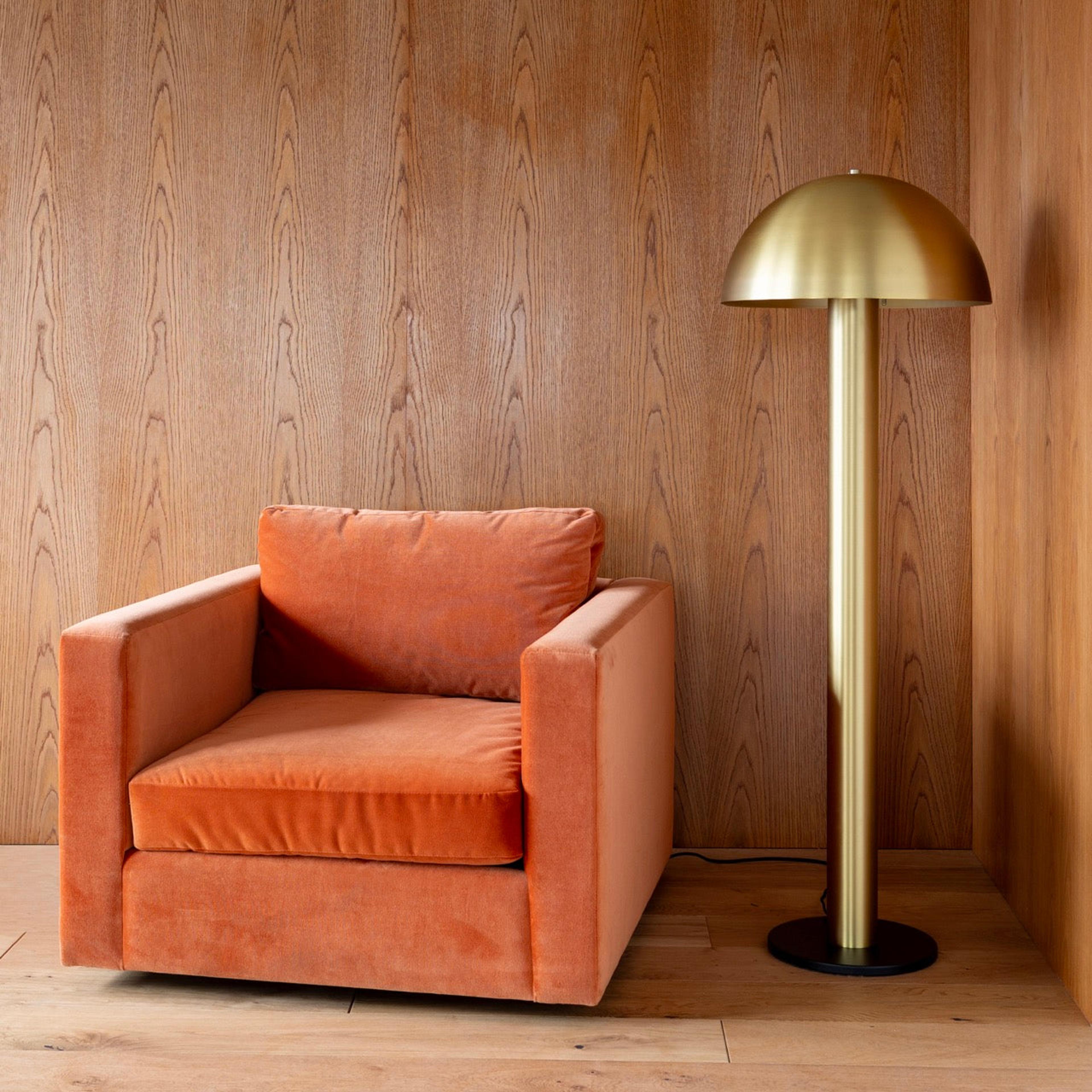 Velvet orange chair with natural brass floor lamp