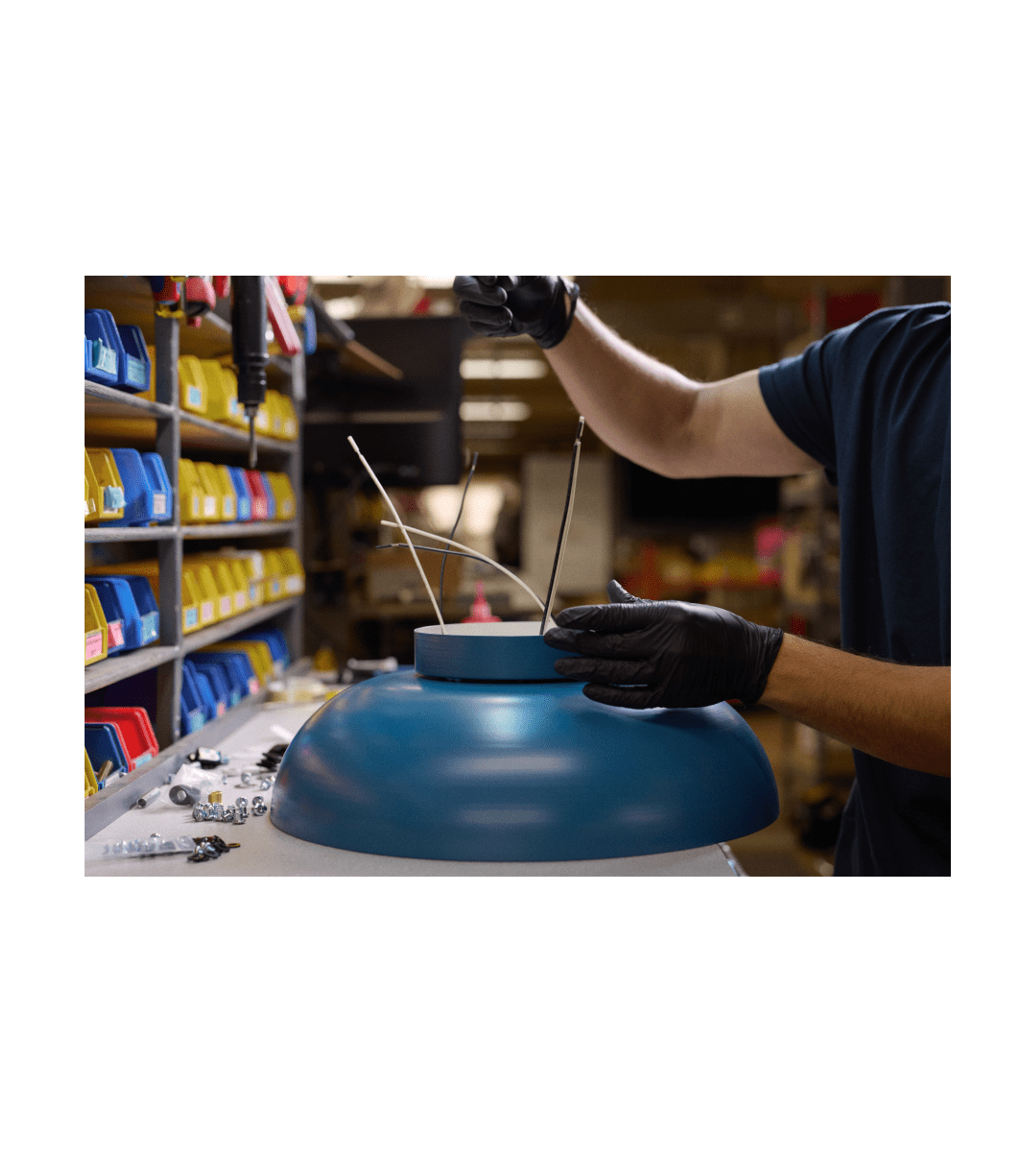 blue lighting fixture being assembled and wired