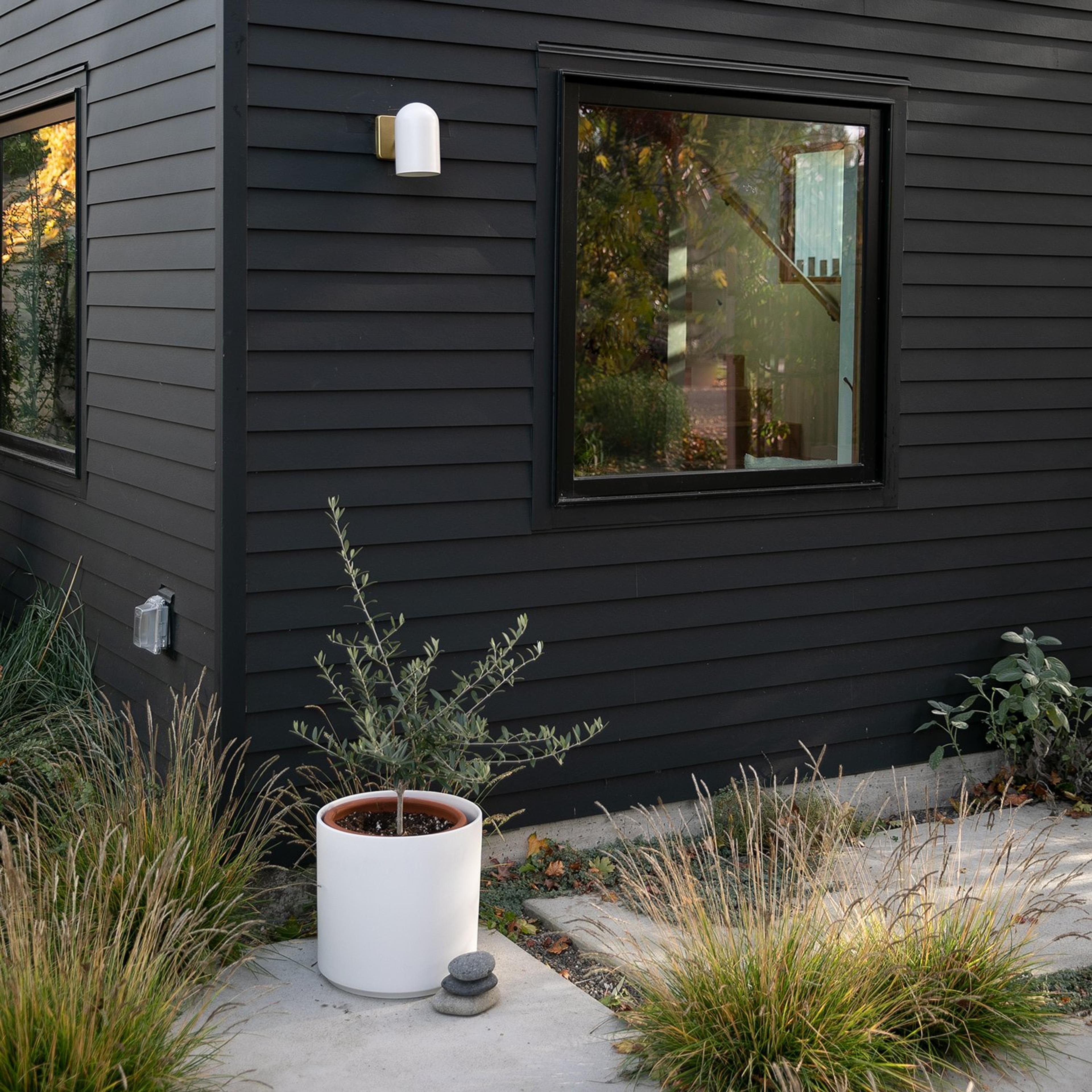 White planter with white outdoor wall sconce 