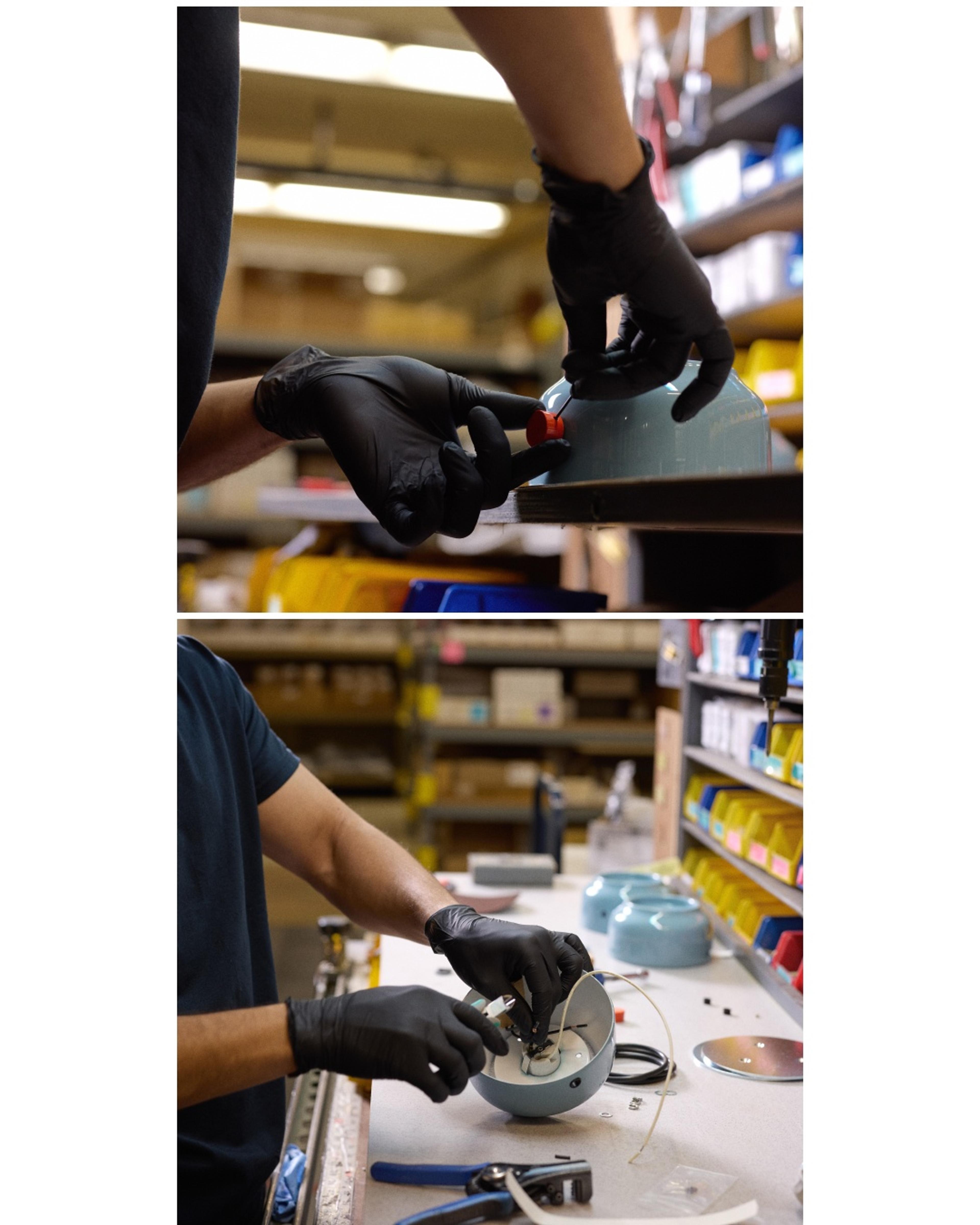 factory worker assembling sky blue base to persimmon dimmer knob at workbench