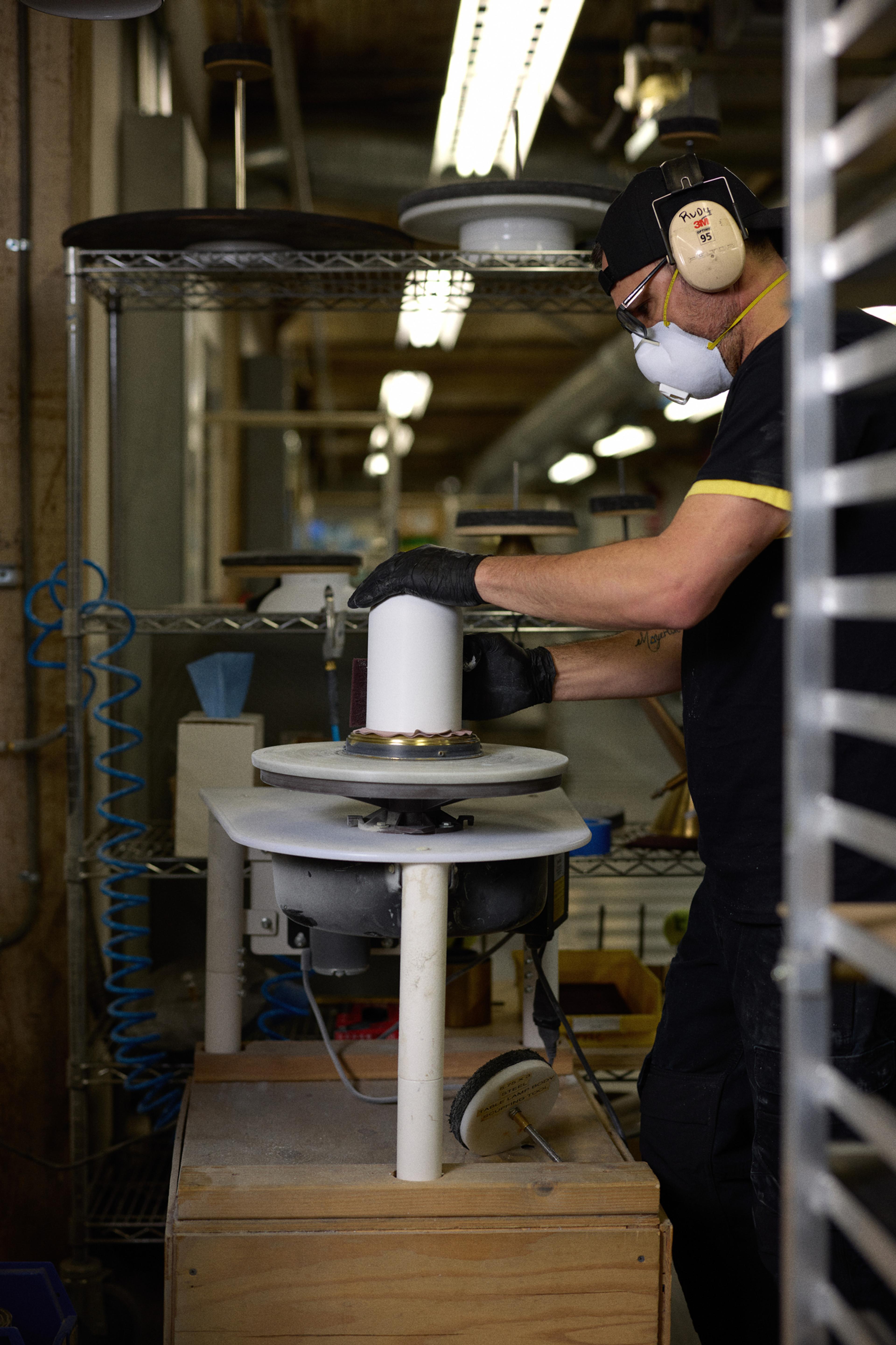 person sanding light fixture