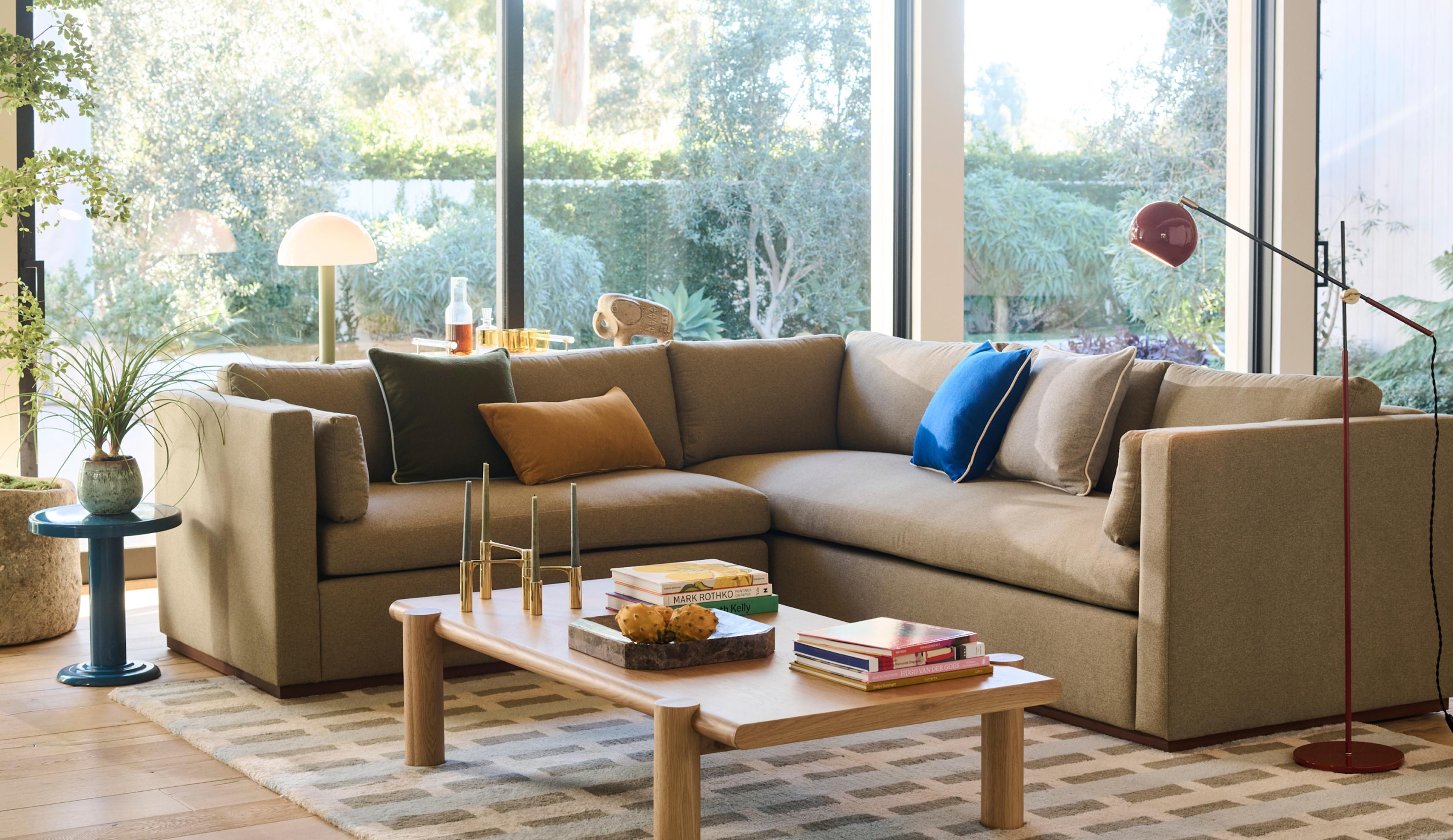 Bright living room with grey couch and colorful accent pillows