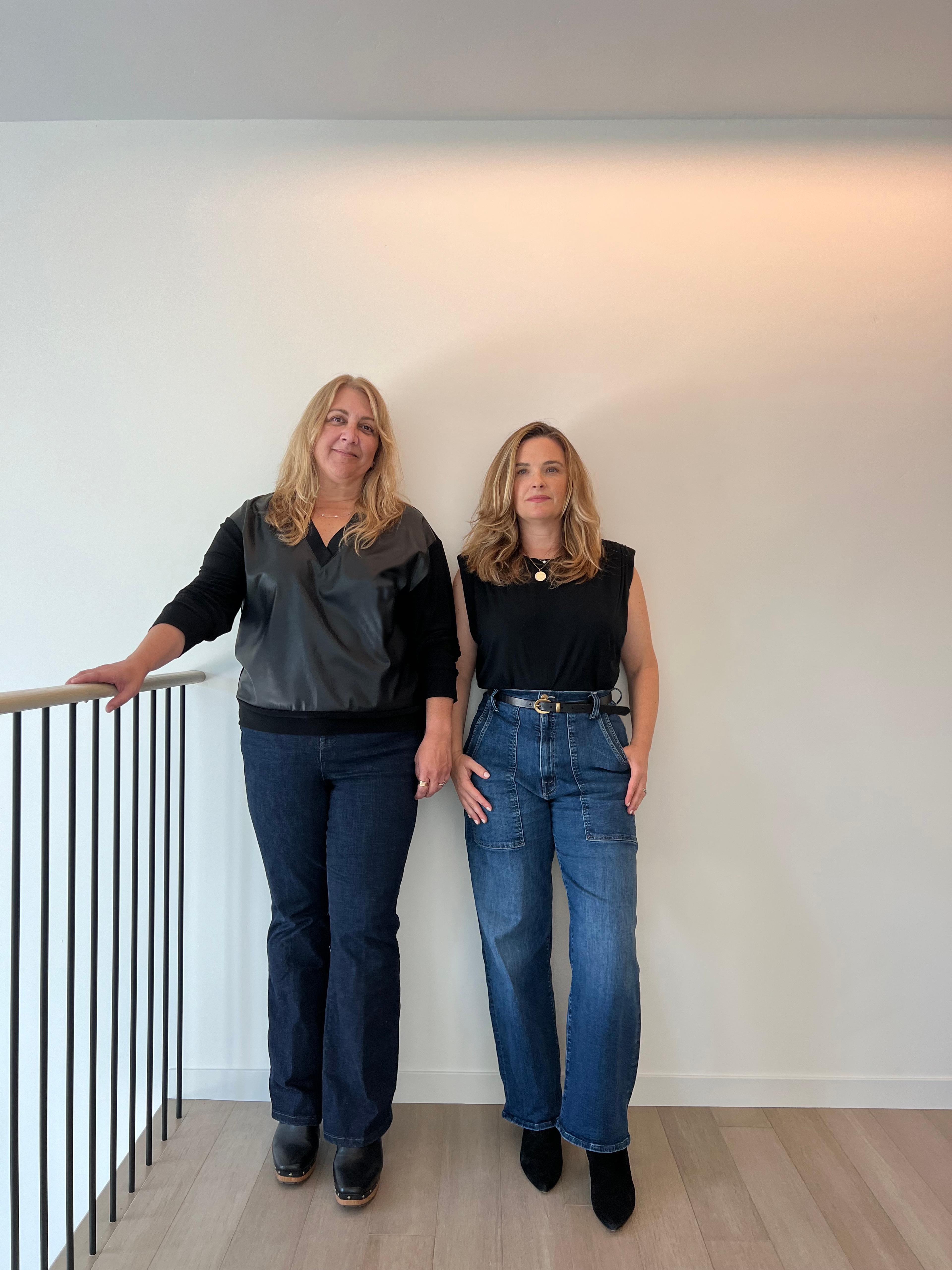Two women standing side by side. 