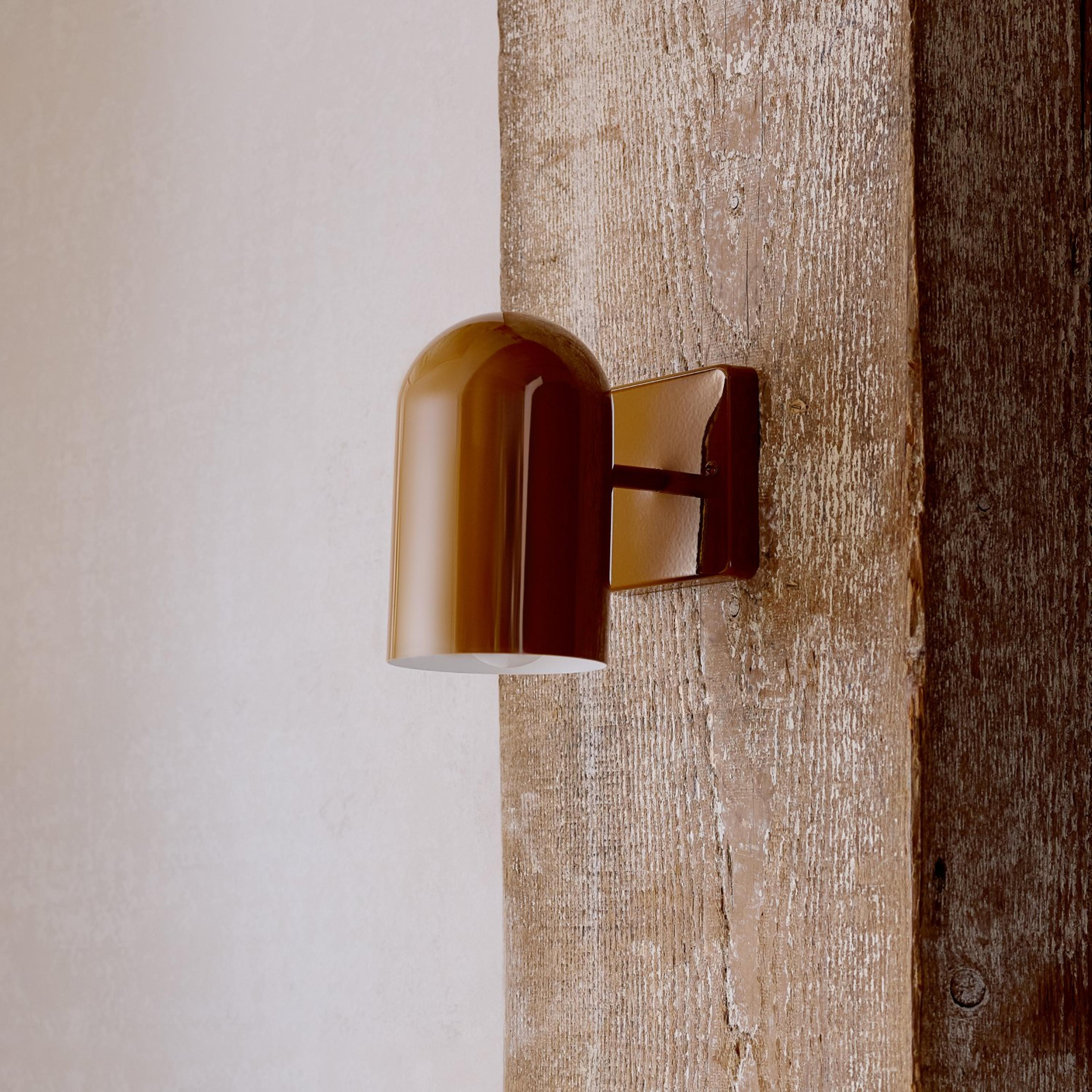ALLEGHENY sconce in butterscotch on a wooded wall