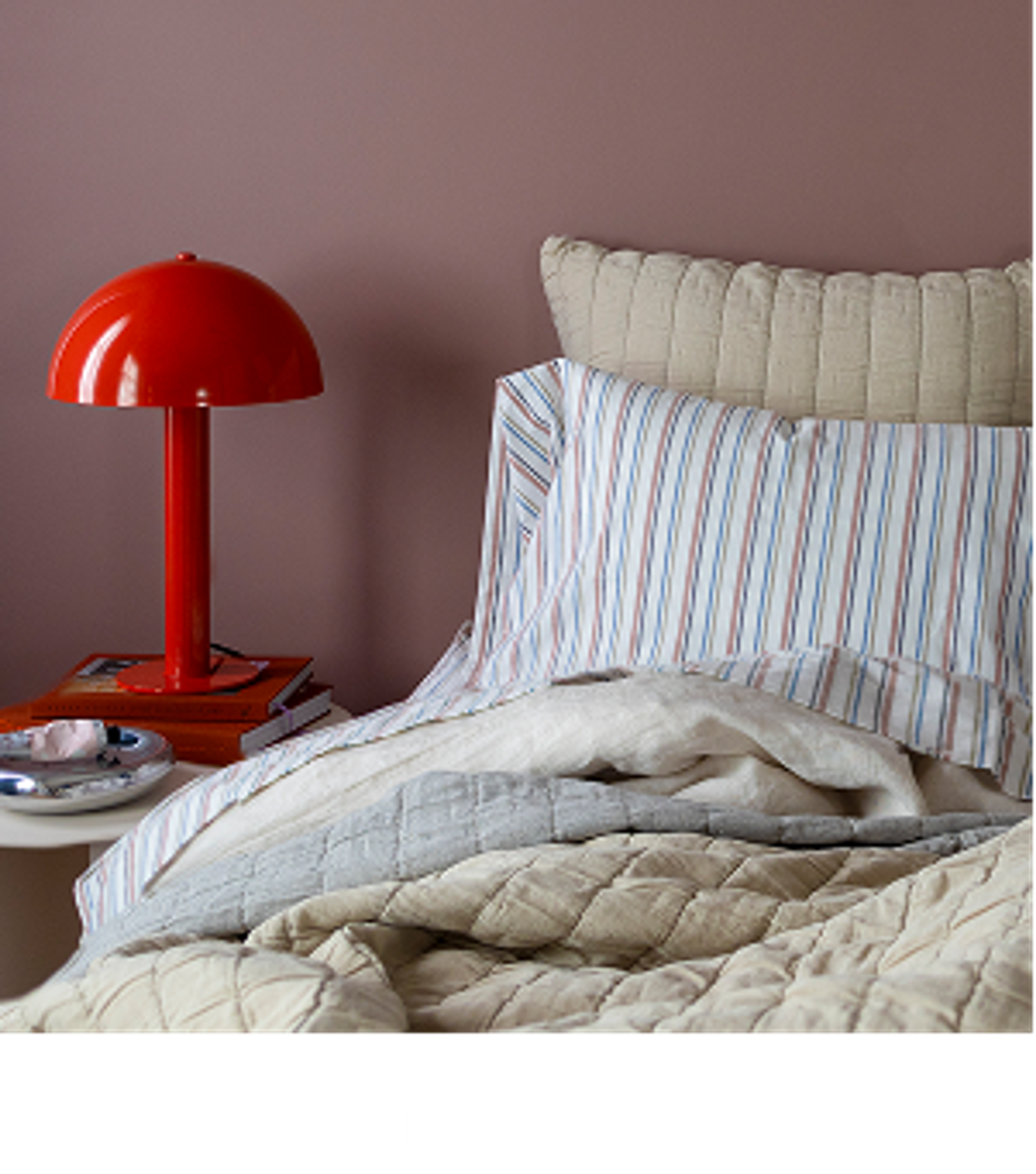 Cozy bed with table lamp on nightstand