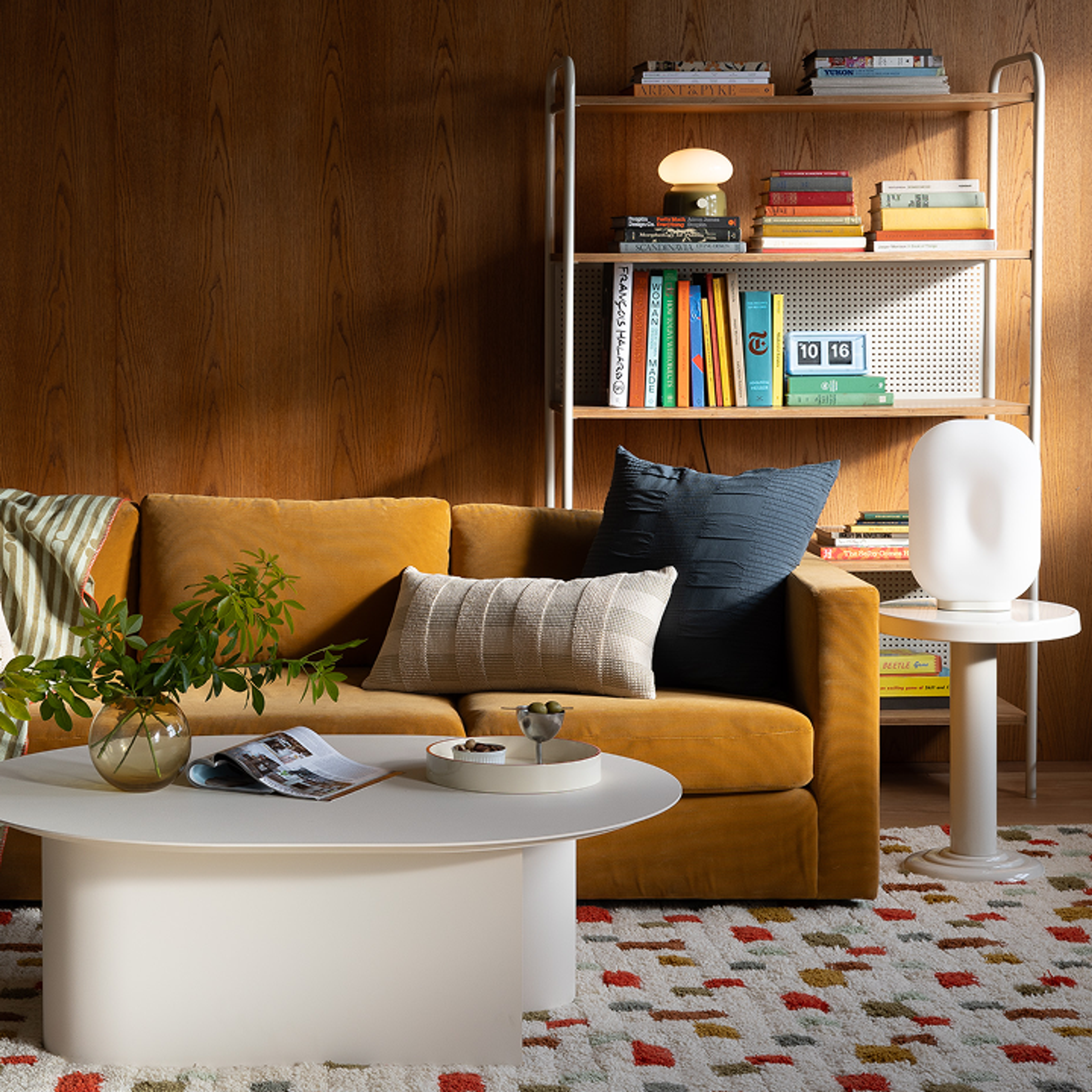 living room scene with couch, coffee table, and book shelf