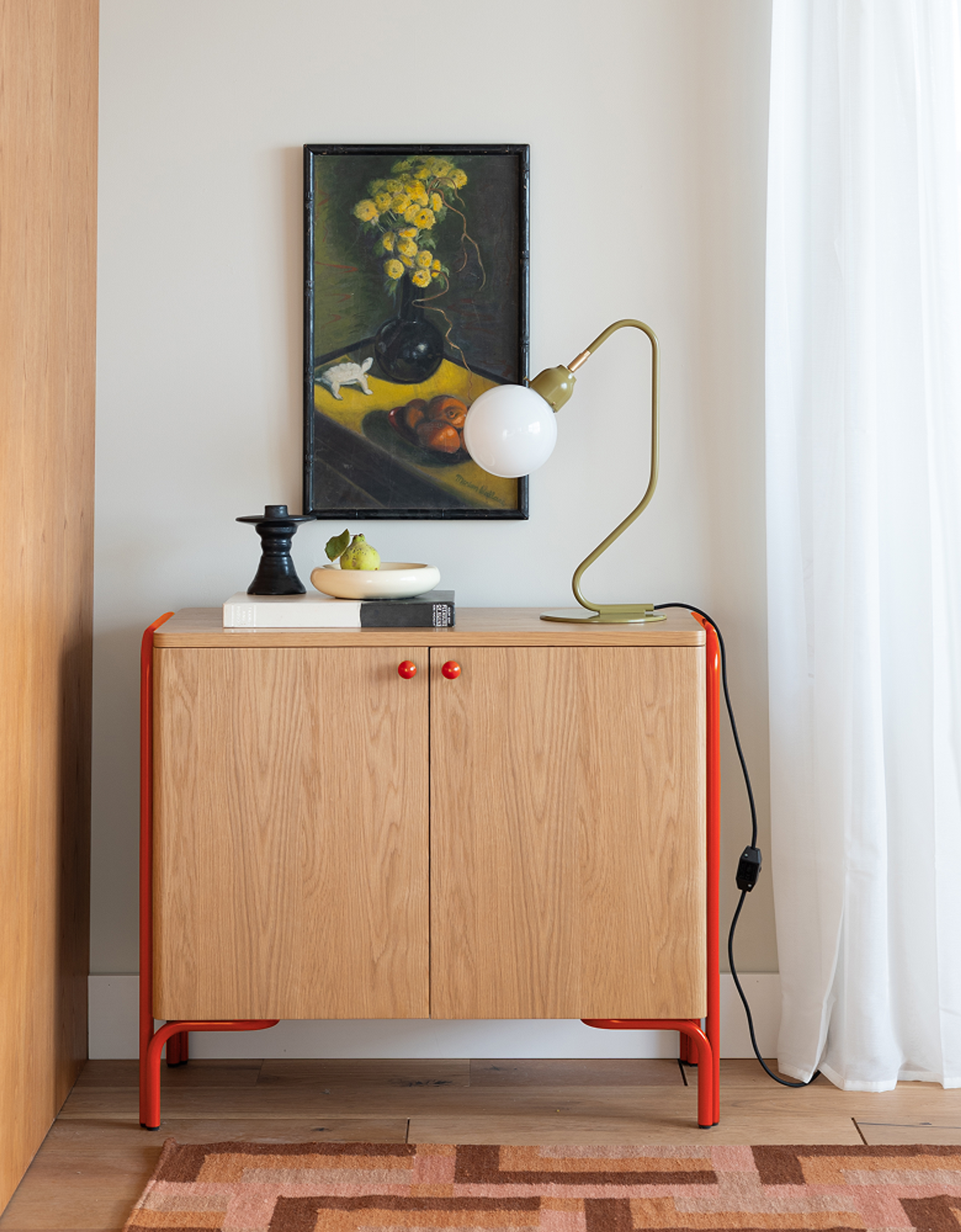 storage cabinet with red accents against a wall