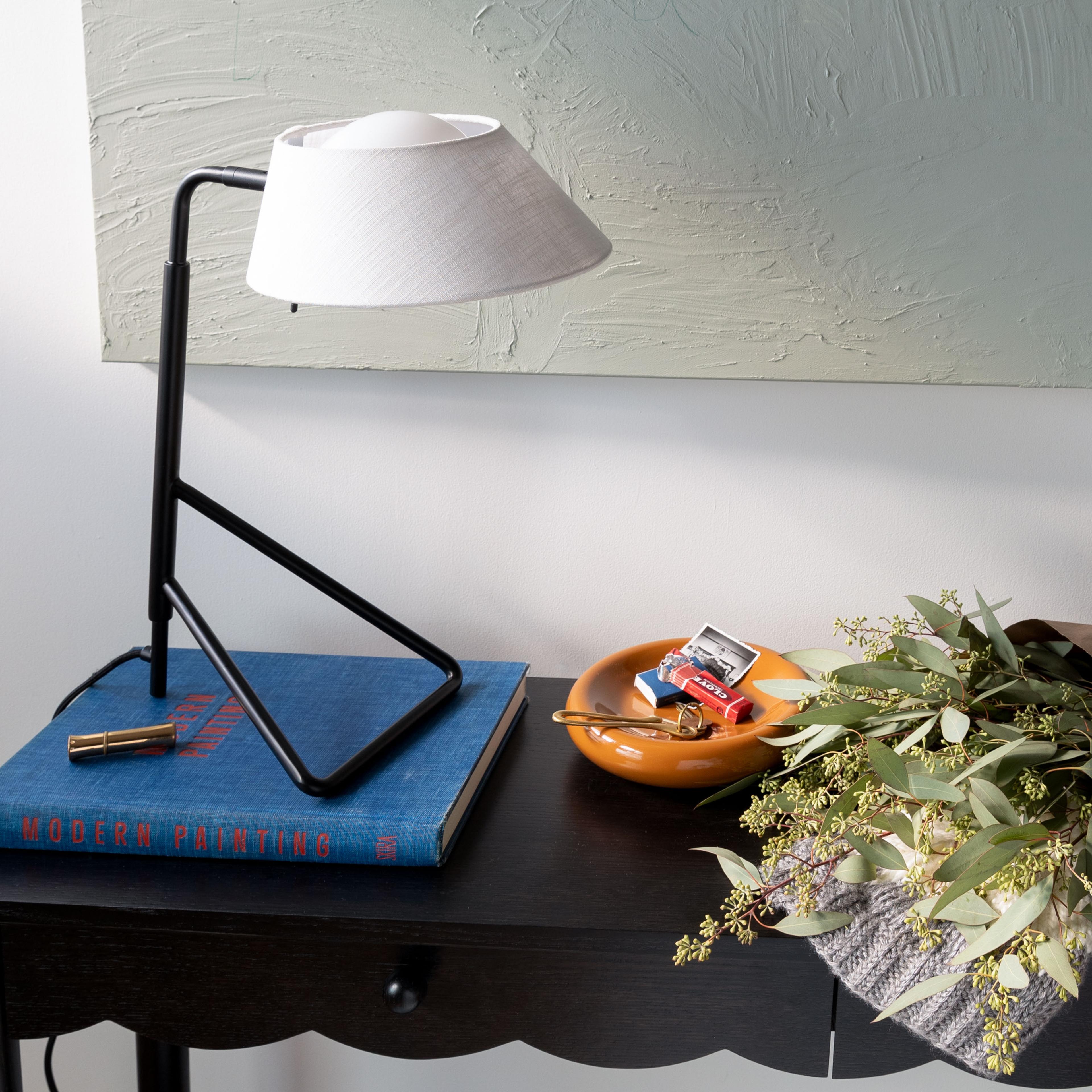 Table lamp on entryway console. 