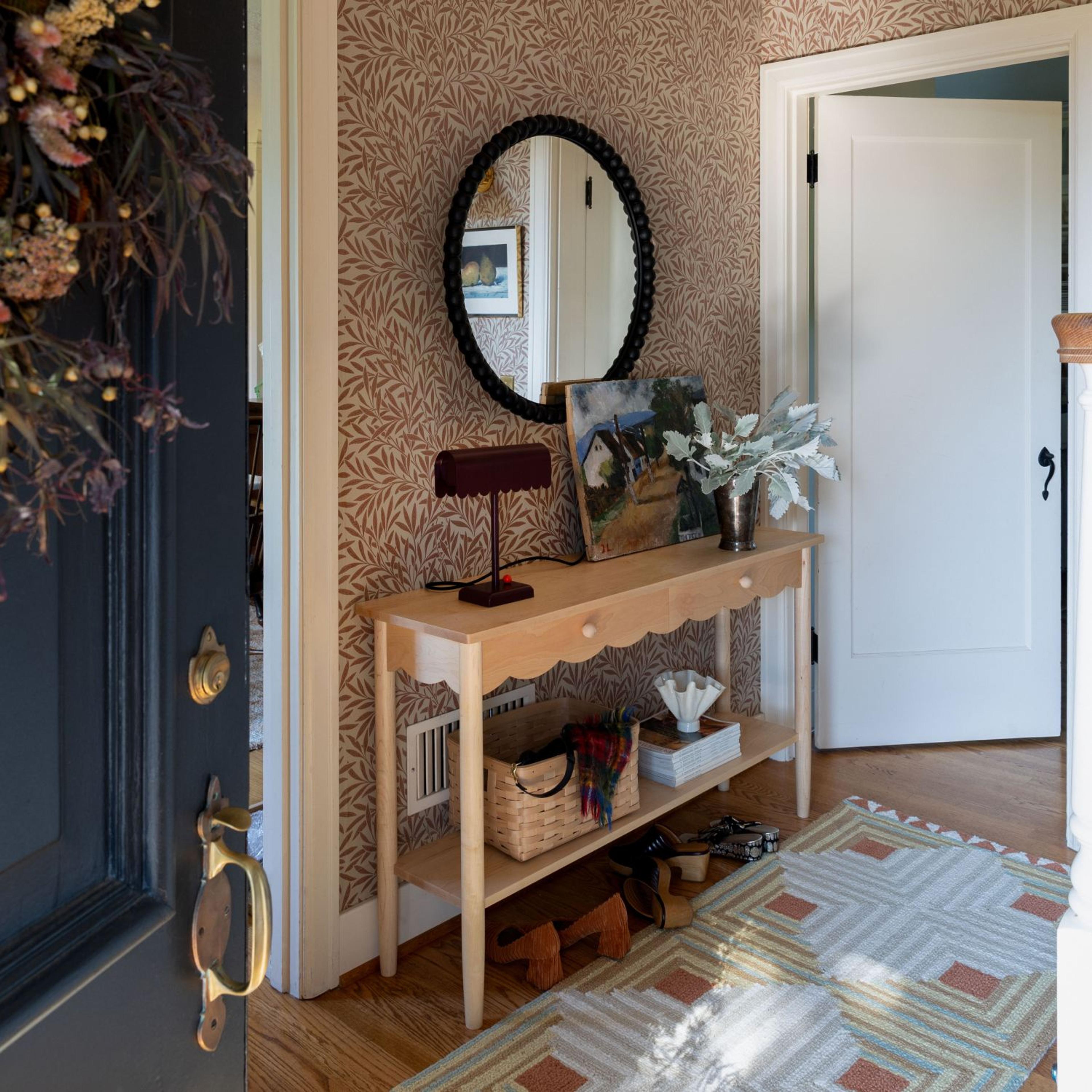 Red bar cart in living room with mini Christmas tree on top