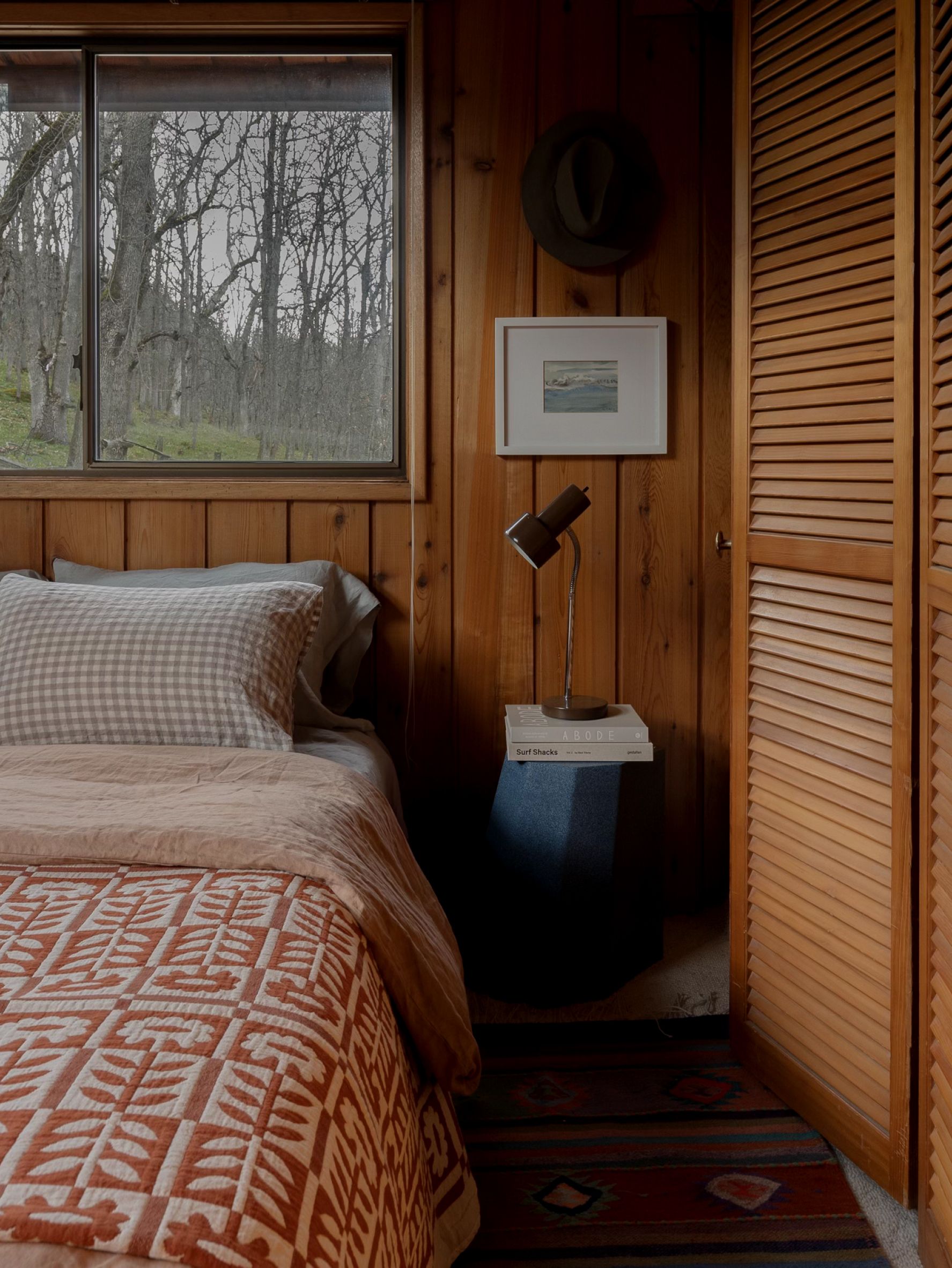 wood paneled room with side table and lamp