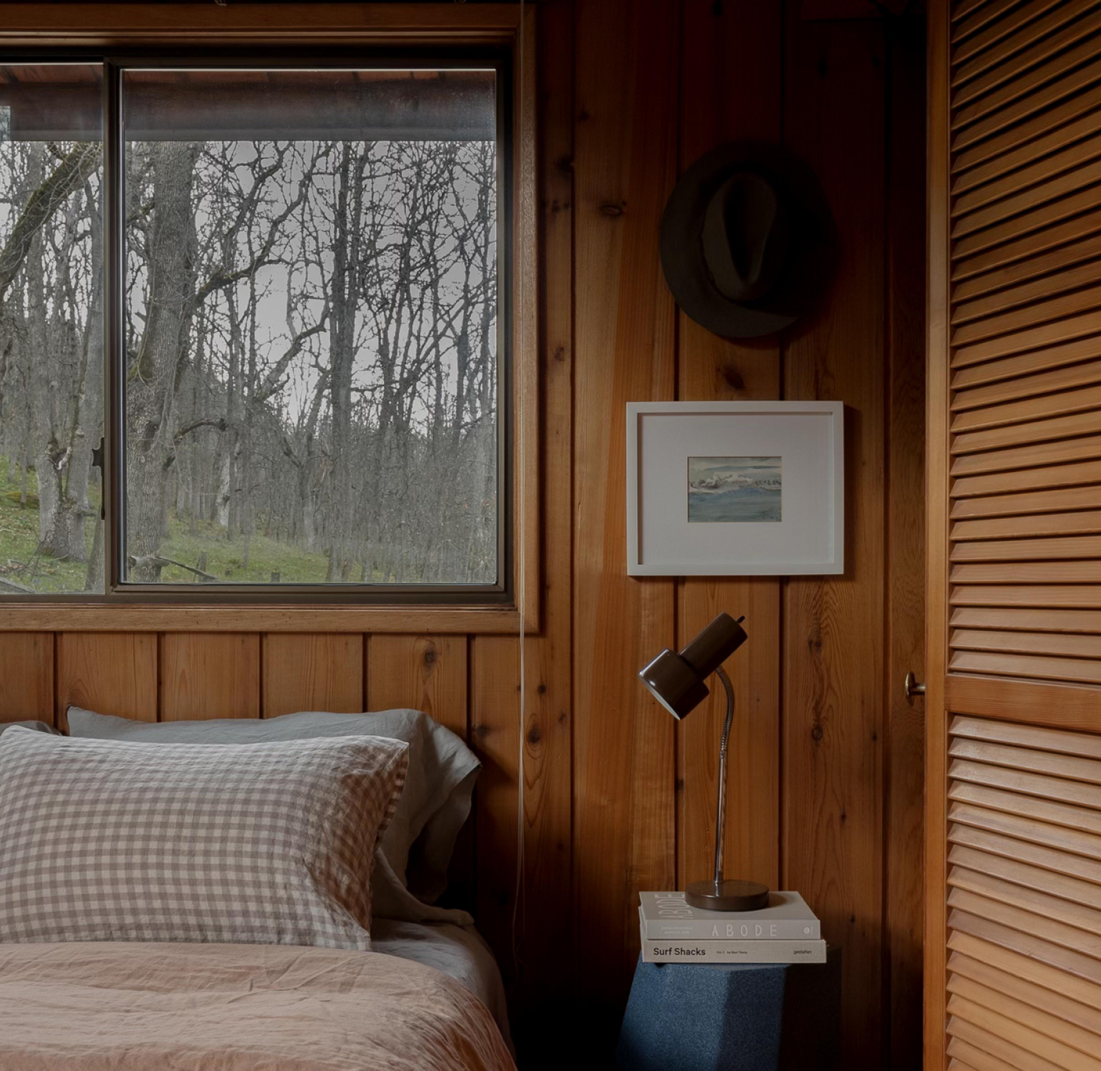 wood paneled room with side table and lamp