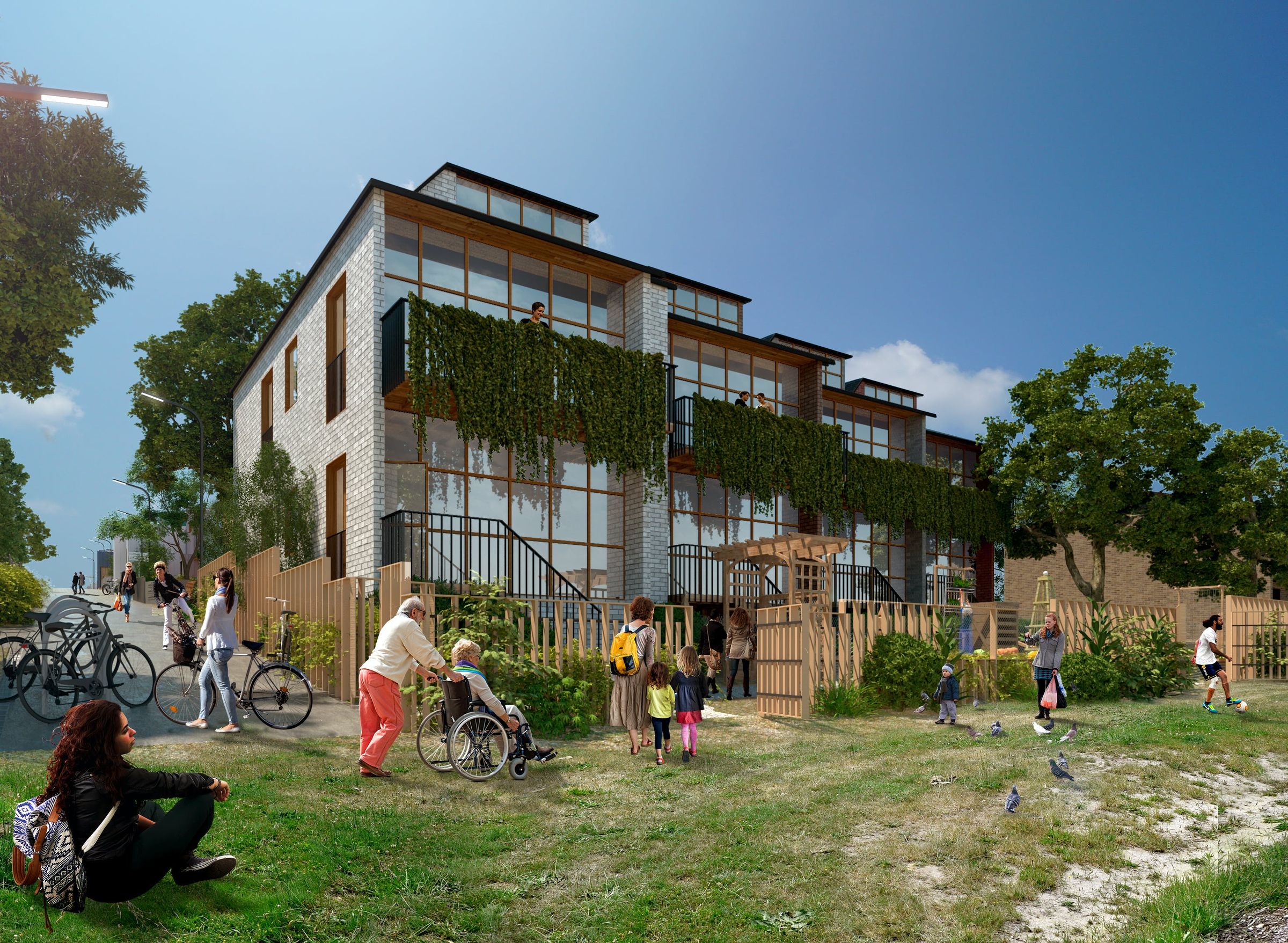 An image of two-storey, glass fronted townhouses leading onto an open green space where people of all ages and abilities are sitting, walking, playing and riding.
