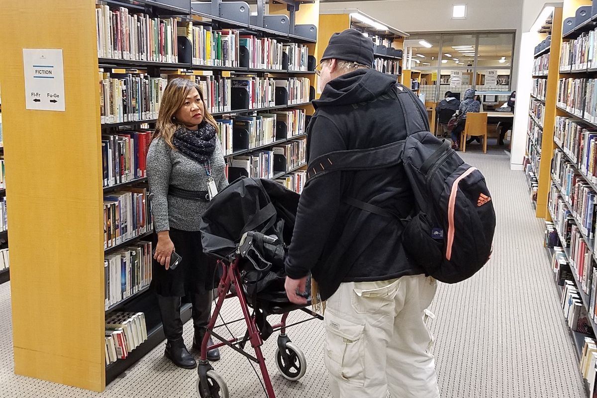 Man talking to library social worker