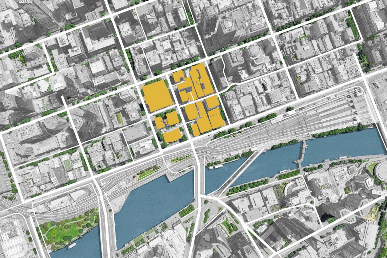 A birds eye map of an urban area separated by a river. Multiple buildings within a four-block area is highlighted in yellow