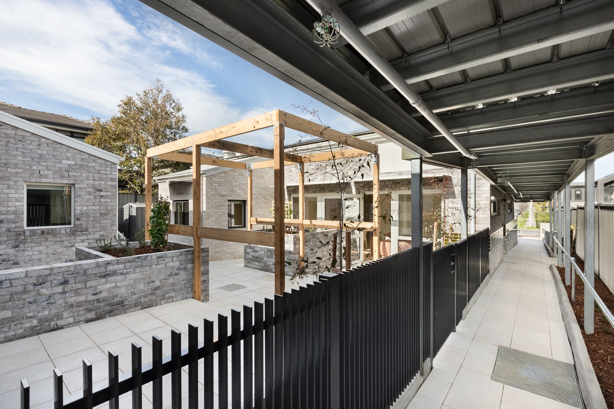 View of shared courtyard and walkway between units.