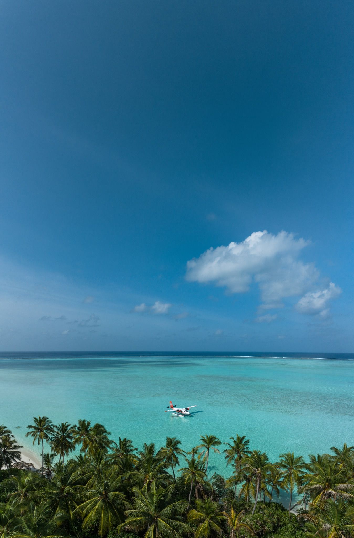 A seaplane resting on a turquoise lagoon