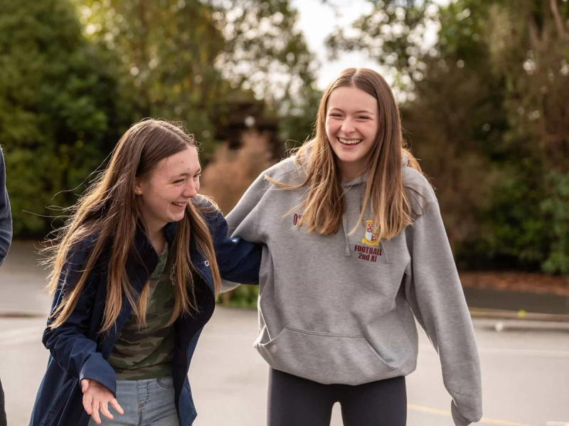 a girl wearing a sweatshirt that says football 2nd xi