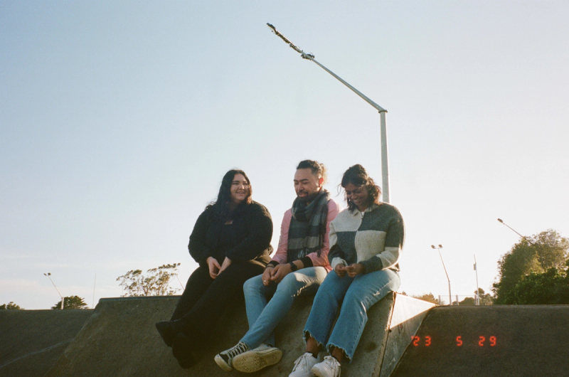 three people are sitting on a ramp with the date 23 5 29