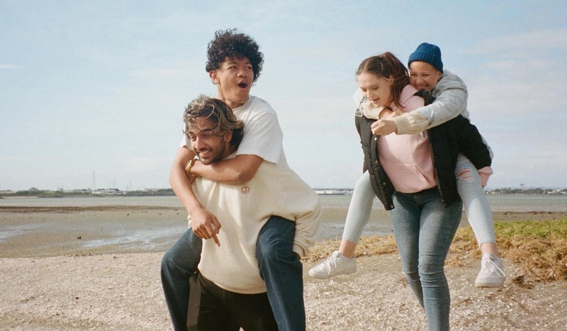 a man is carrying a woman on his back on the beach a man is carrying a woman on his back on the beach