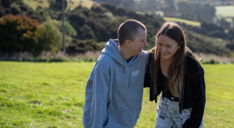 a man wearing a grey hoodie that says ' dirty dancing ' on it