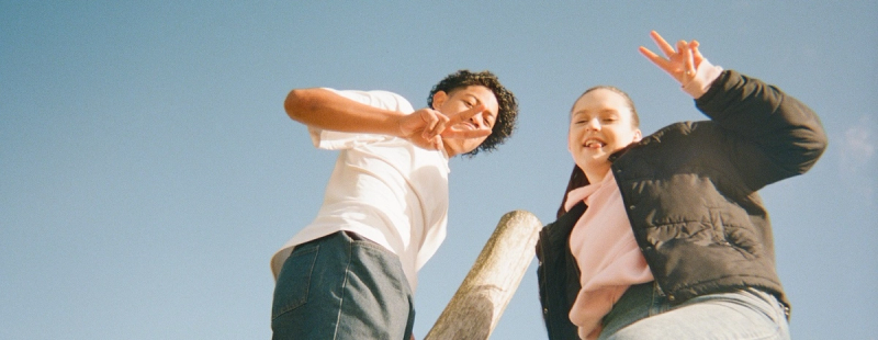 a boy and a girl are giving the peace sign