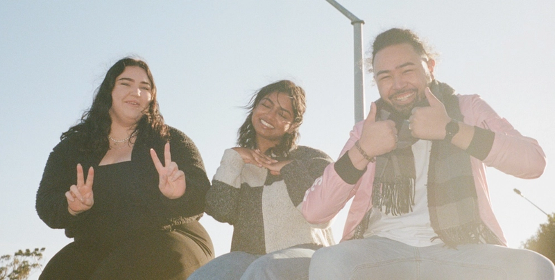 a man and two women are giving the peace sign a man and two women are giving the peace sign
