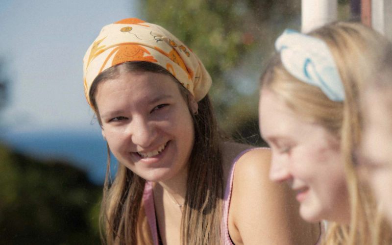 a woman wearing a headband with the letter c on it