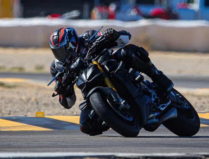 Ducati Streetfighter V4 S leaning through a corner on a racetrack.