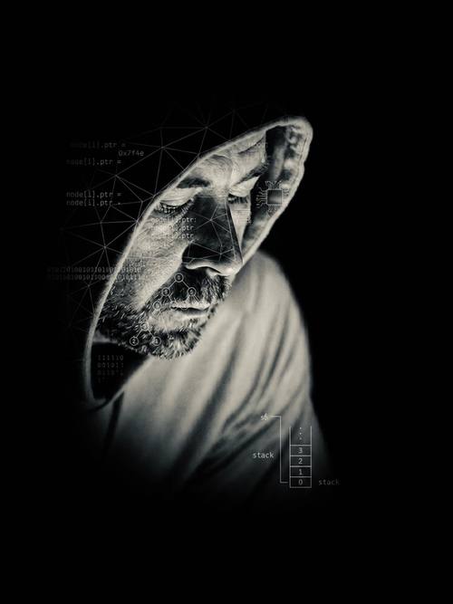 Cinematic monochrome portrait of Vincent Passaro in a dark hoodie. Shadows and white technical schematics symbolize the intersection of leadership and systems.