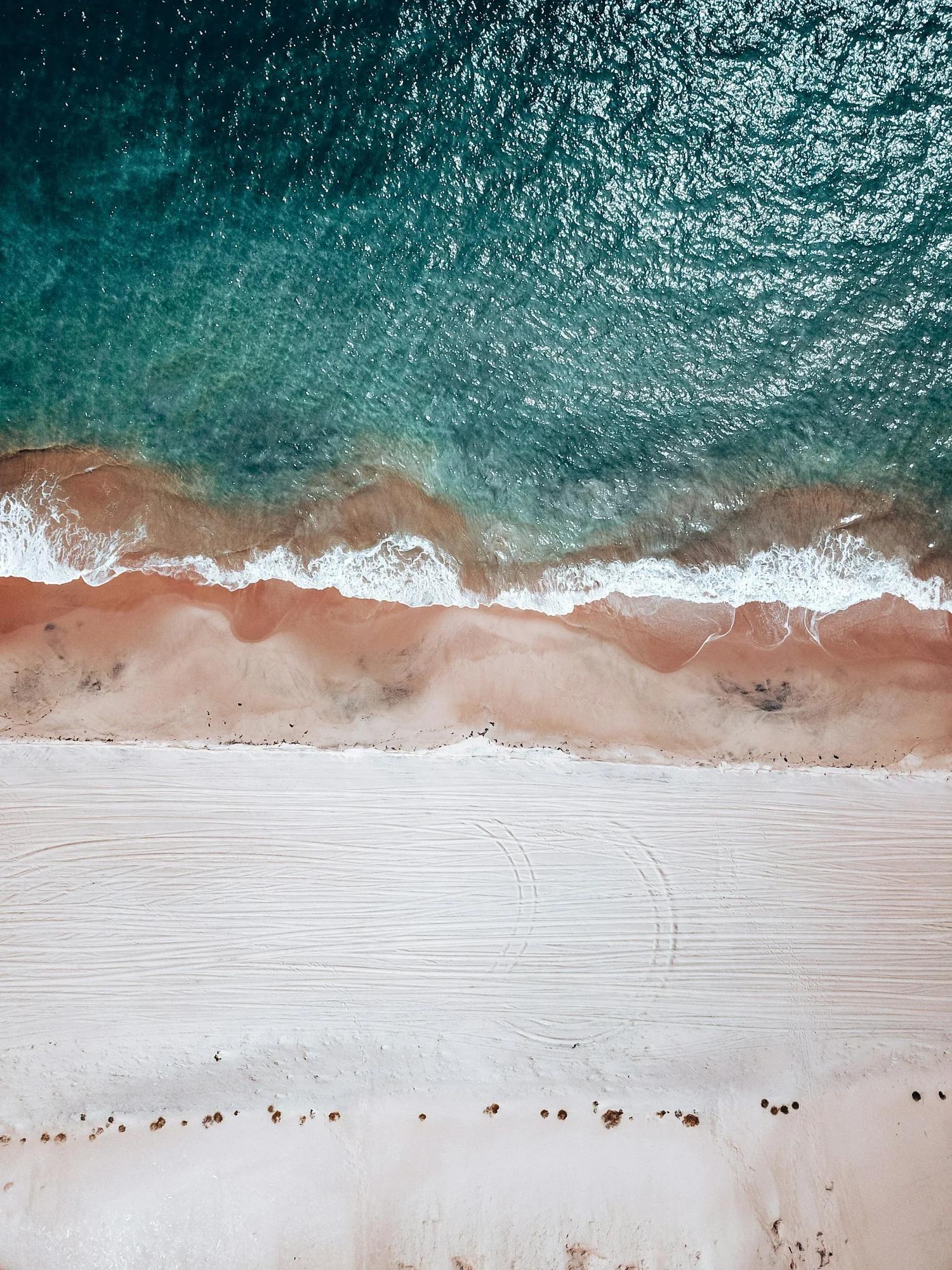Margaret River road and beach with ocean waves.