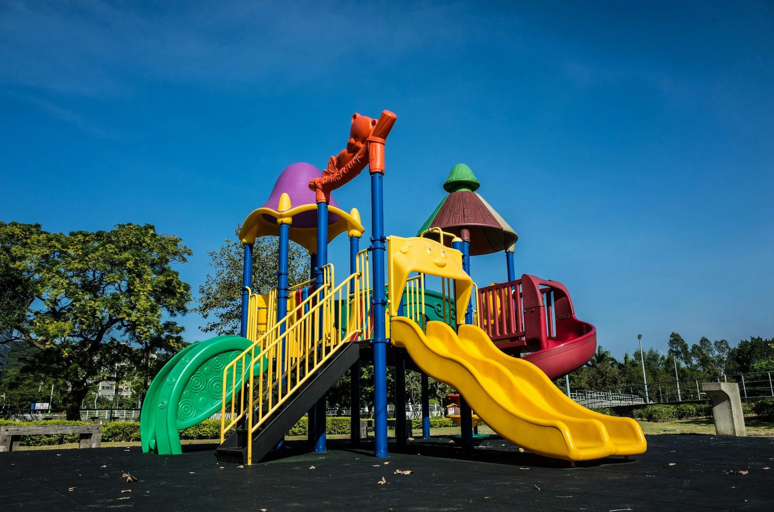 Image of a playground found in Margaret River wine region with a yellow slide and colourful play equipment. 