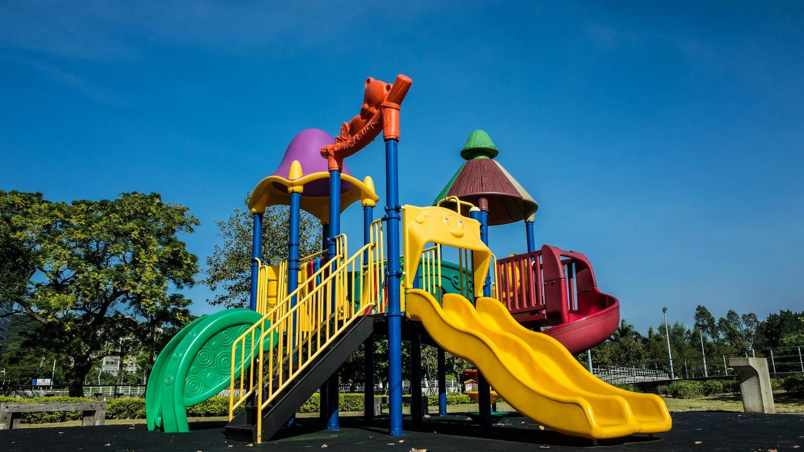 Image of a playground found in Margaret River wine region with a yellow slide and colourful play equipment.