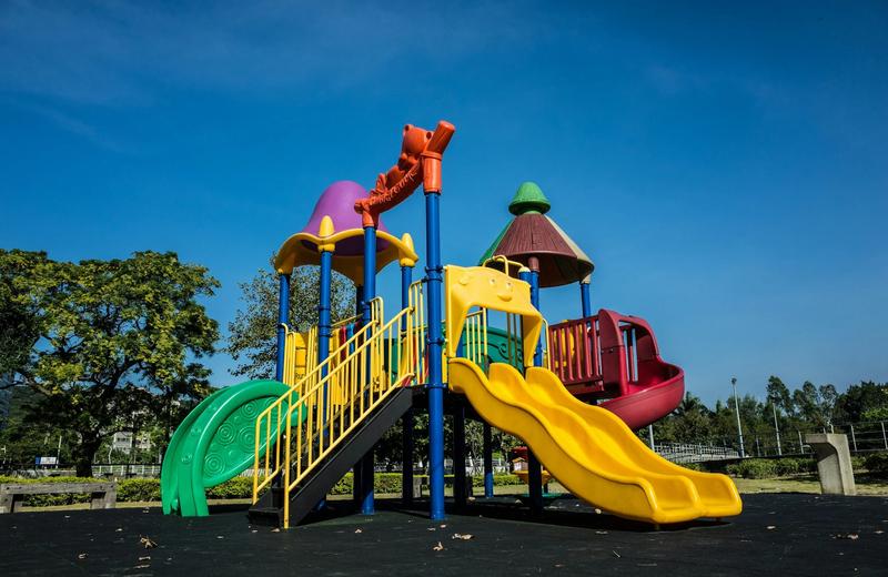 Image of a playground found in Margaret River wine region with a yellow slide and colourful play equipment.
