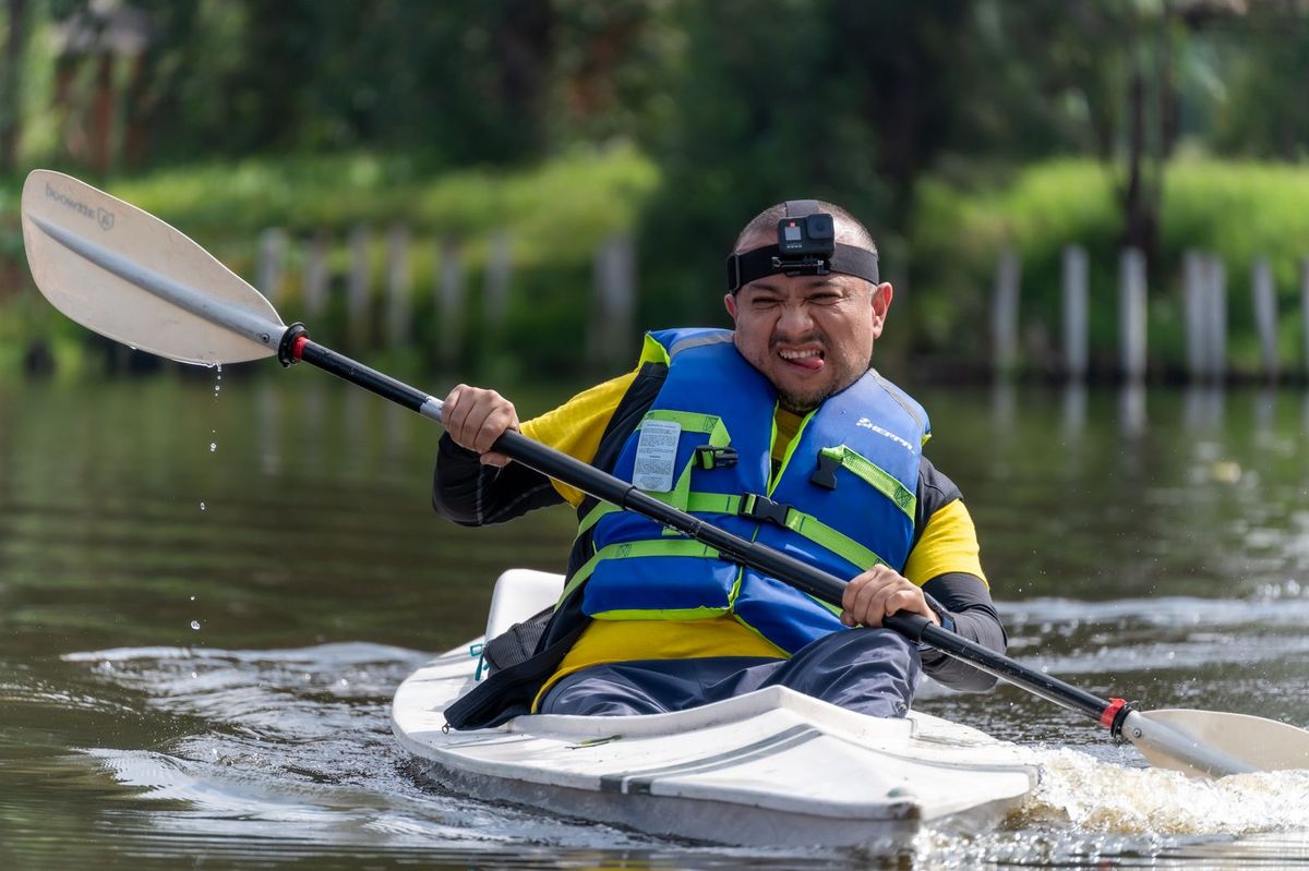 A kayaker paddling calm water