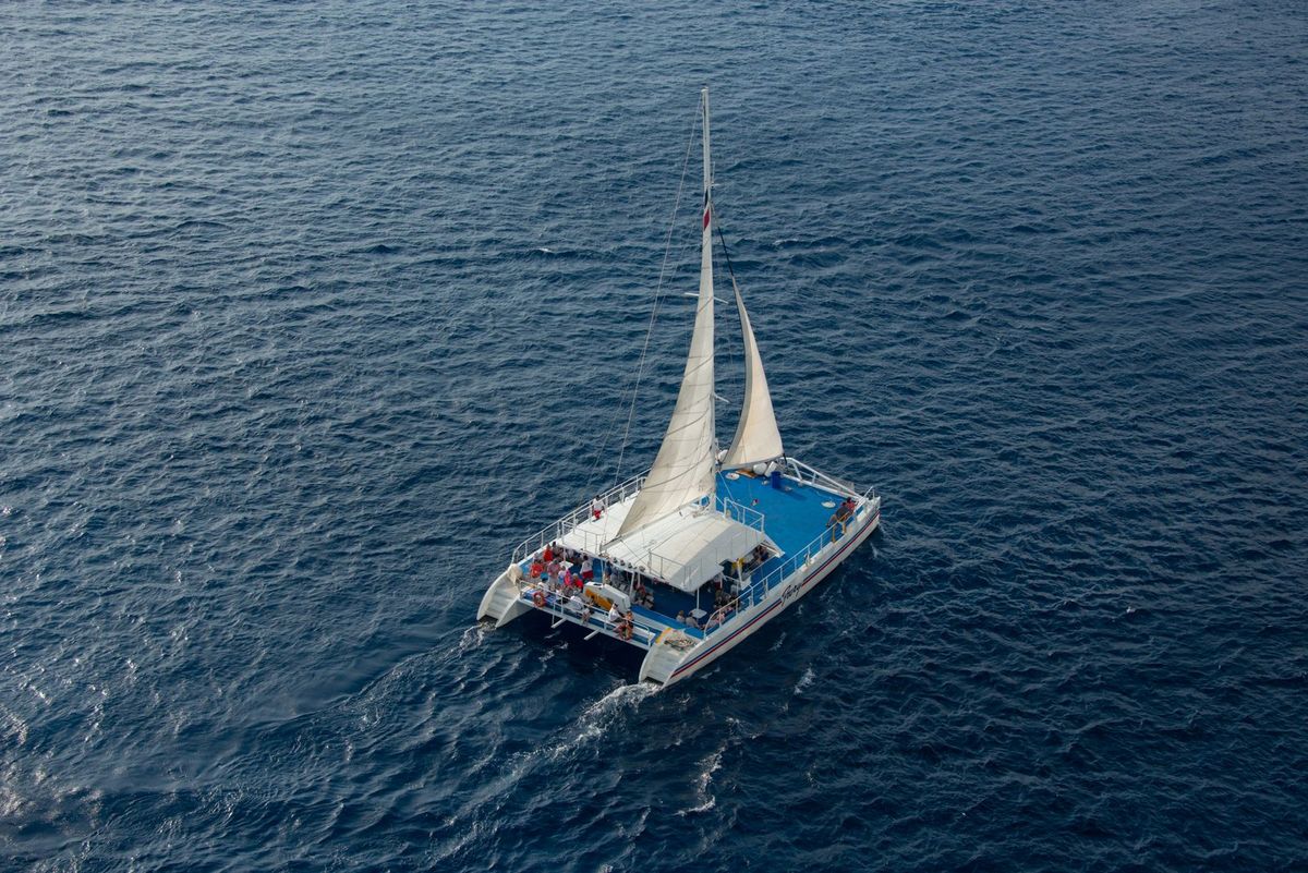 Catamaran sailing over blue tropical water