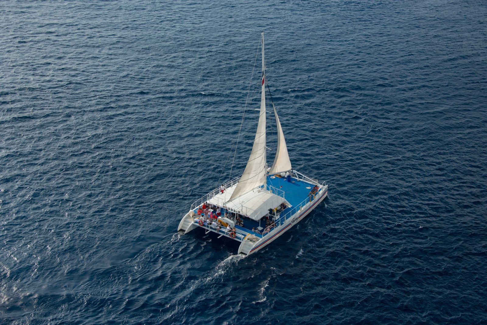 Catamaran sailing over blue tropical water