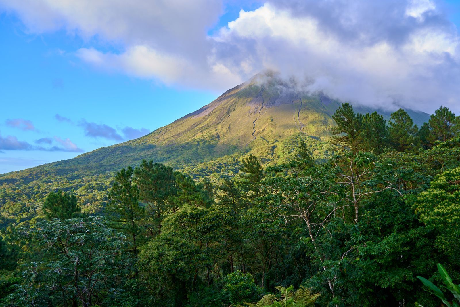 Wide Costa Rican landscape with forested hills and clouds