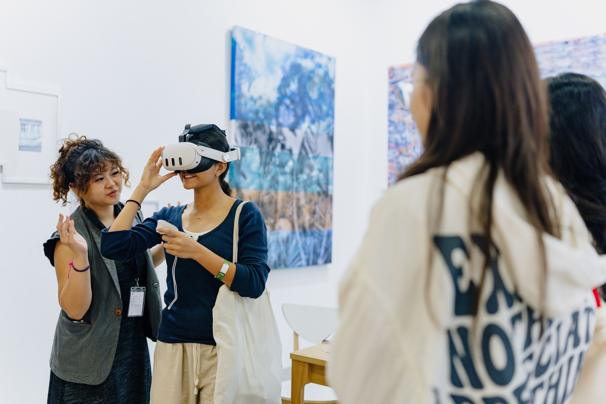 Visitor viewing artworks in a gallery booth at ART SG