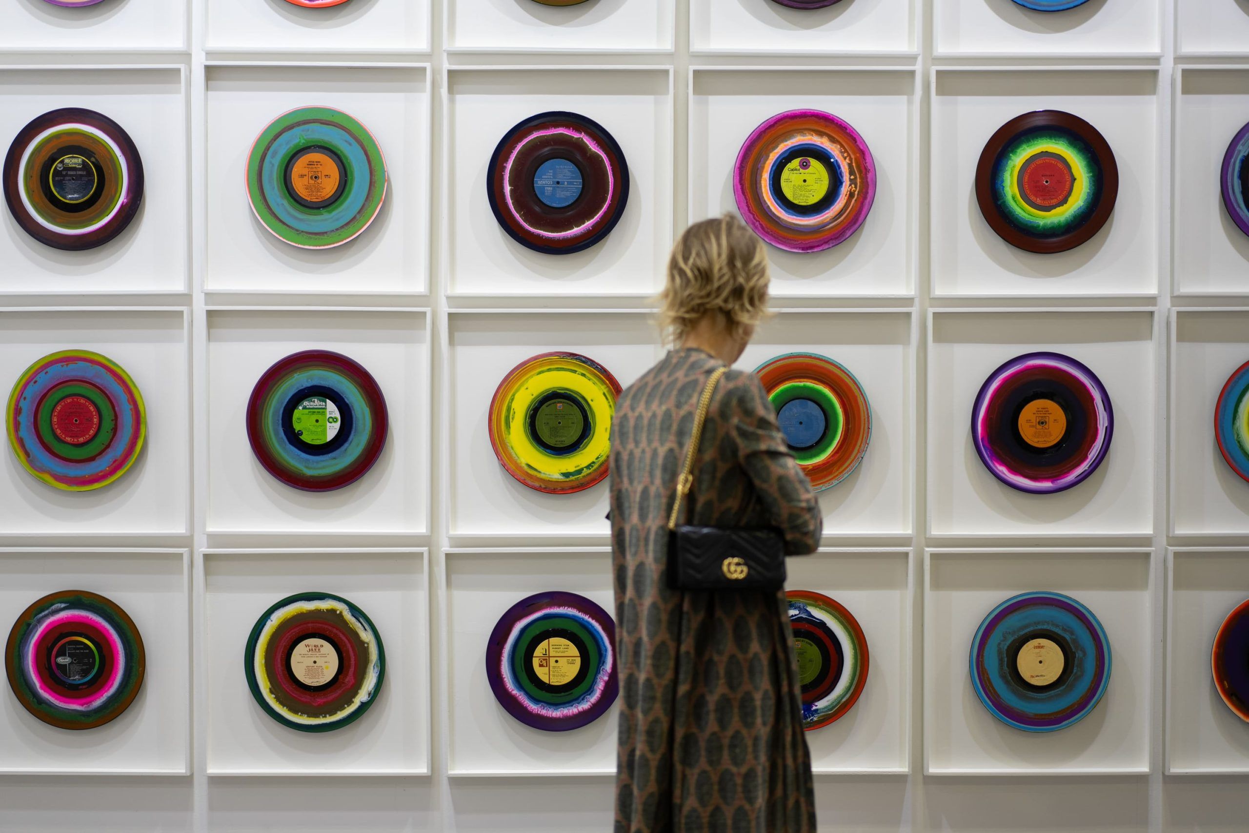 Visitor viewing circular artworks at ART SG