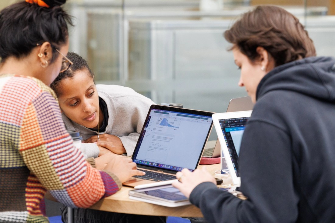 Columbia University students studying on laptops