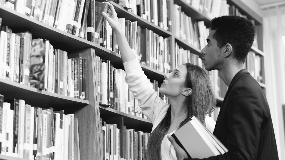 Two young scholars in a library.