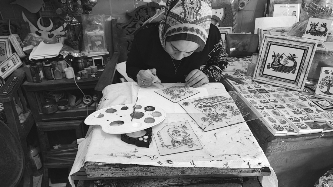 Woman painting at a table.