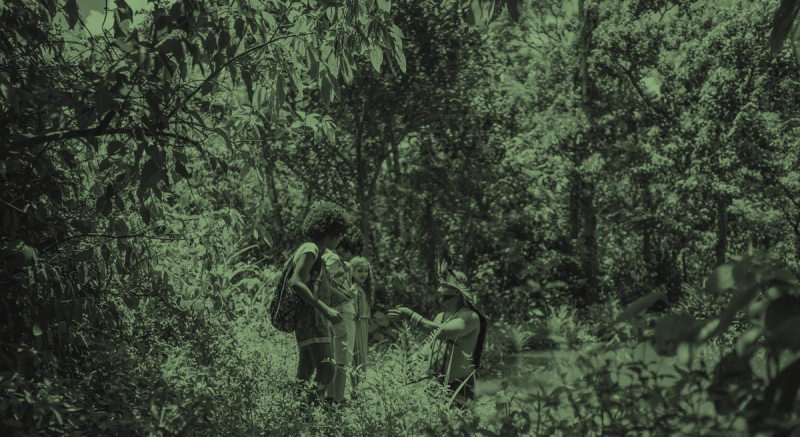 An indigenous man showing how to use a trap to fish