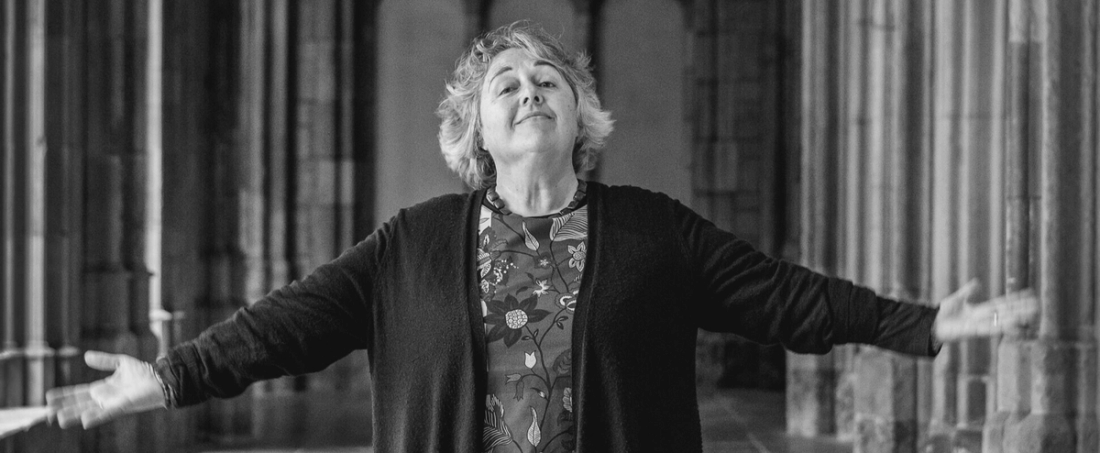 Rosi Braidotti standing, arms outstretched