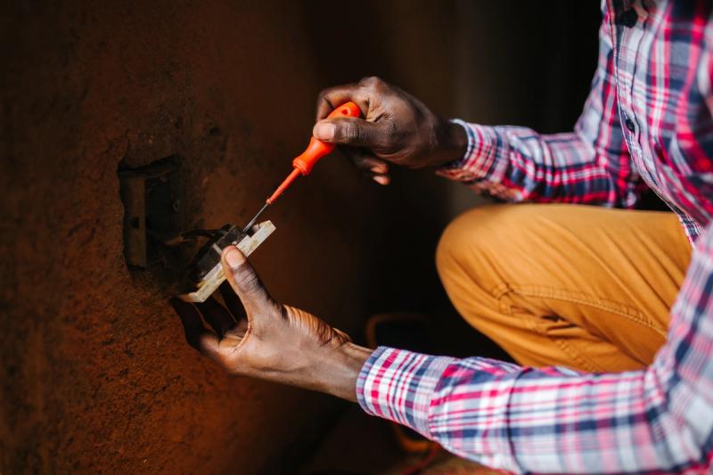 A man fixes an electrical outlet.