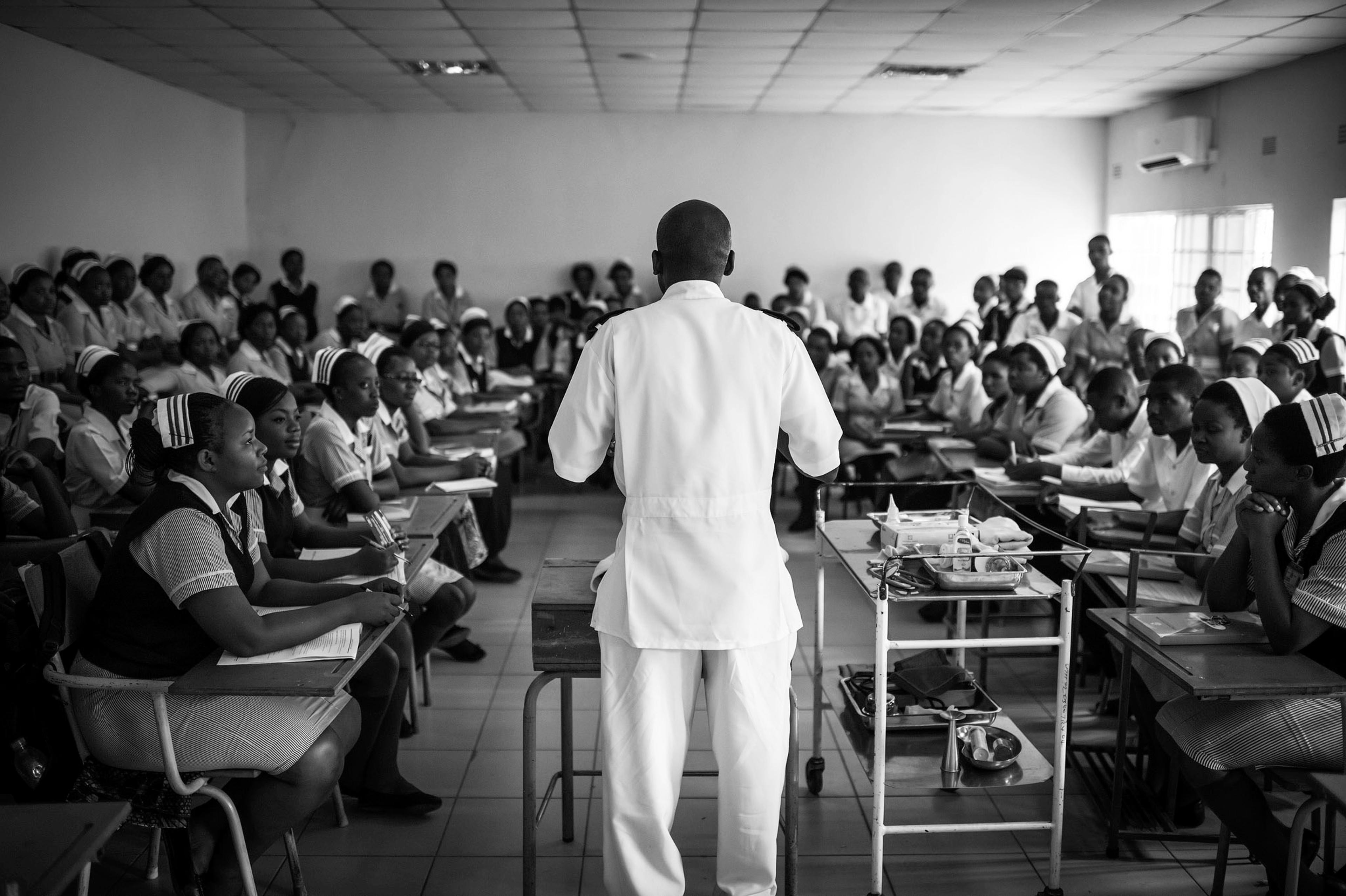 A teacher gives a lecture to a room of nursing students.