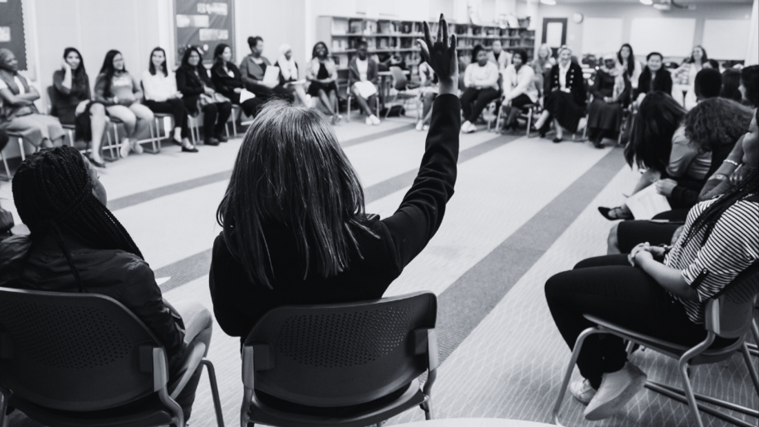 Woman holding her hand up in a room