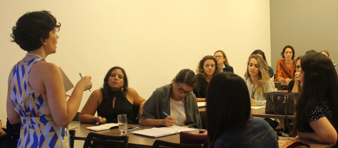 Women leaders sitting in a classroom, taking notes during a workshop.