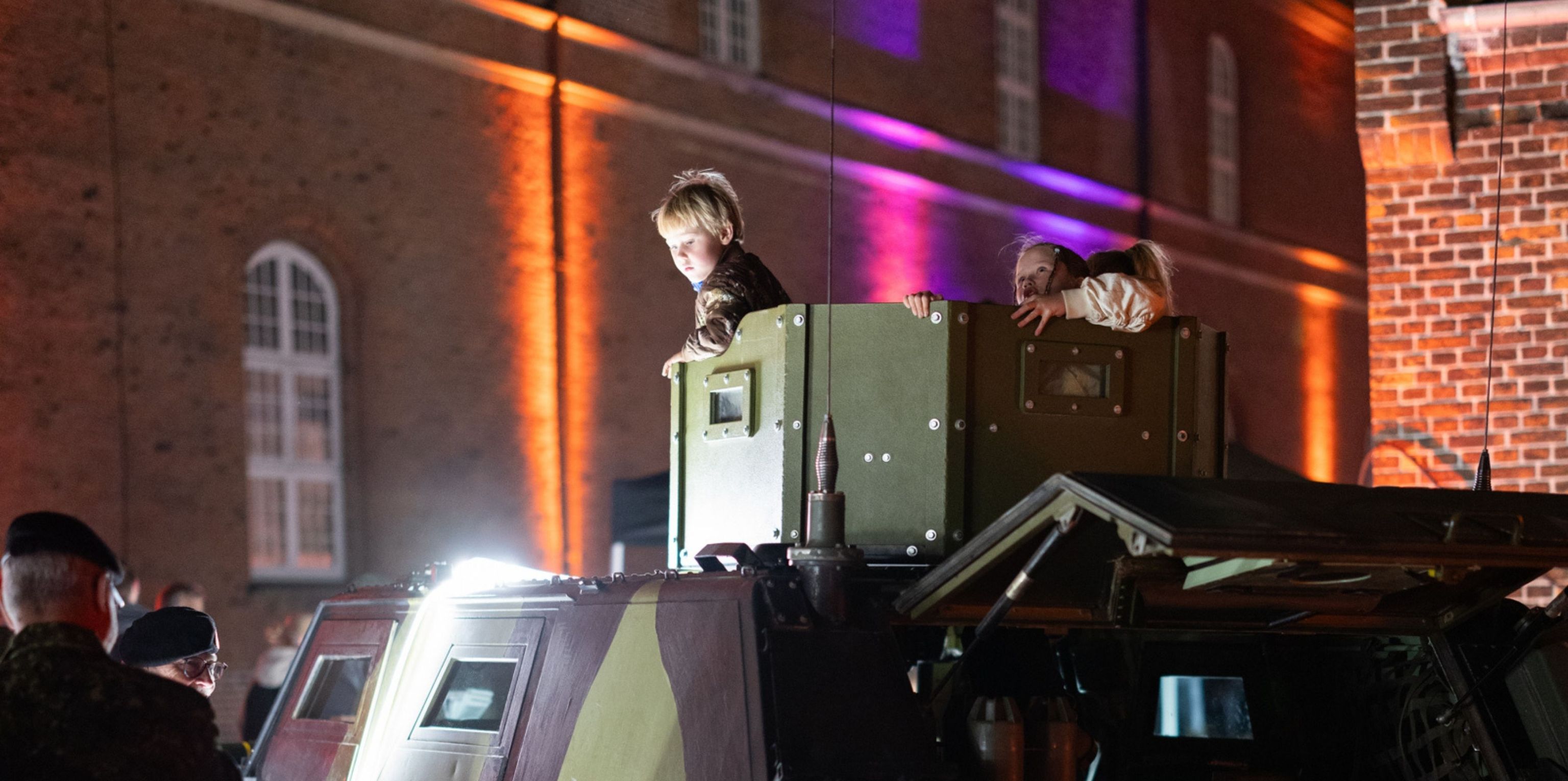 Children sitting in an armoured vehicle