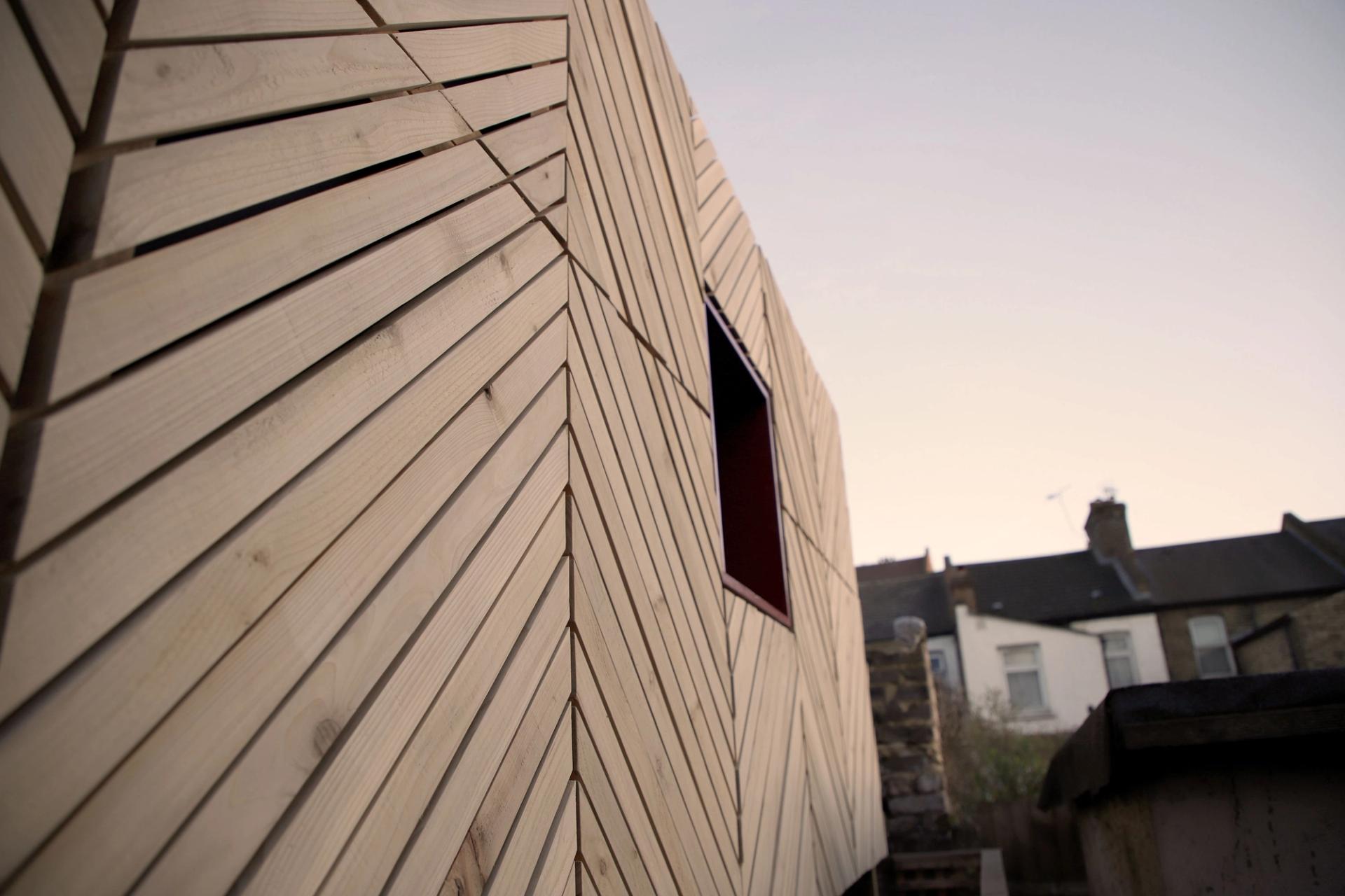 A close up exterior photograph of the western red cedar cladding for a garden room in an East London garden
